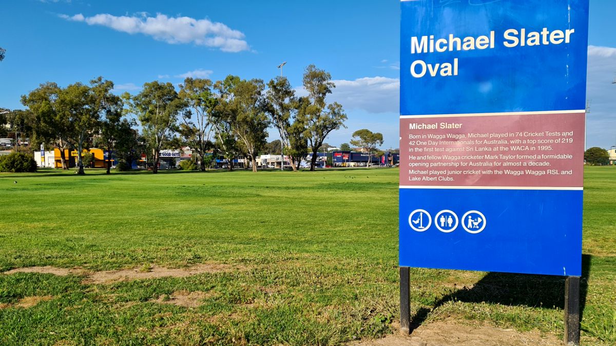 Large sign with details of cricketer Michael Slater  beside cricket ground