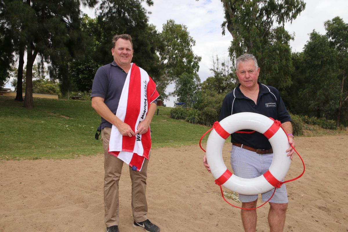 Two men at beach look ready for swim