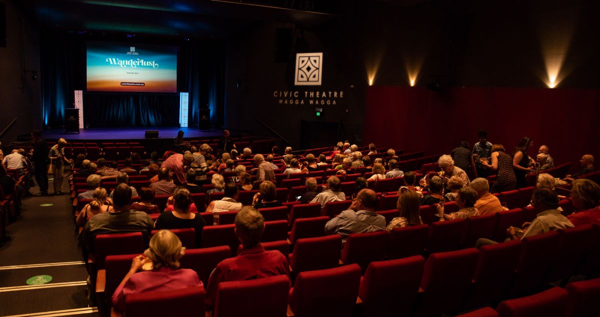 Backs of heads of people seated in theatre