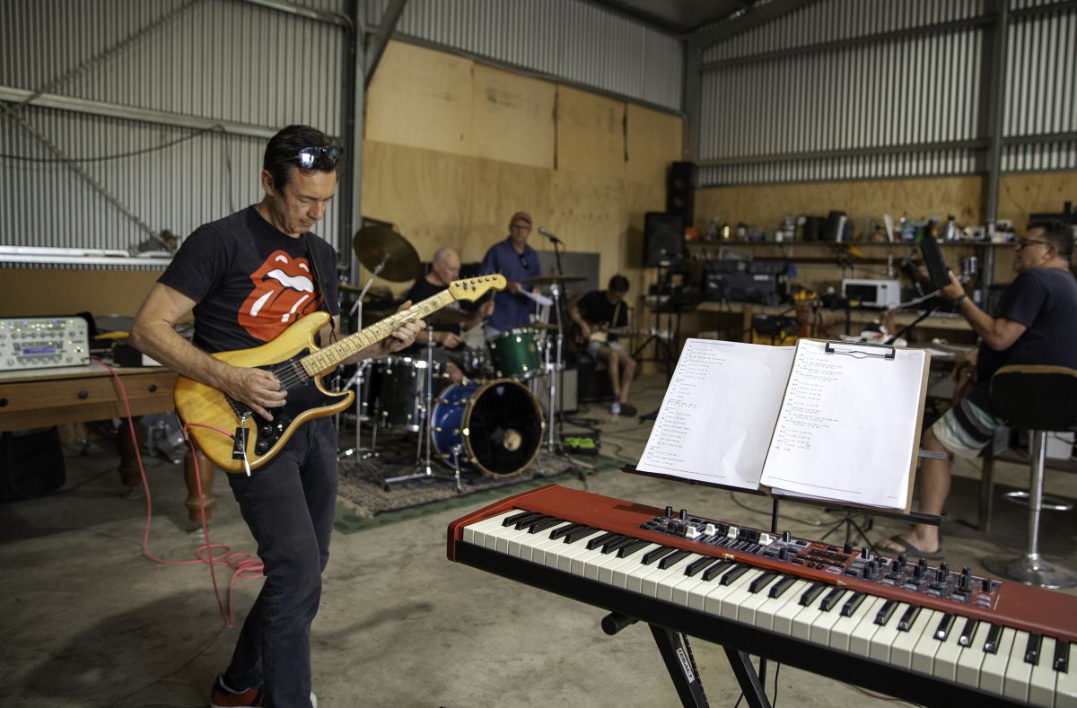 Male musicians in shed rehearsing