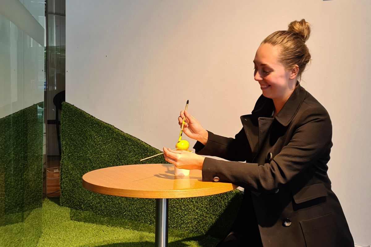 Woman painting egg