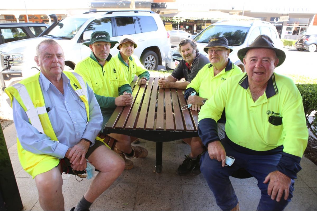 men sitting at a street table