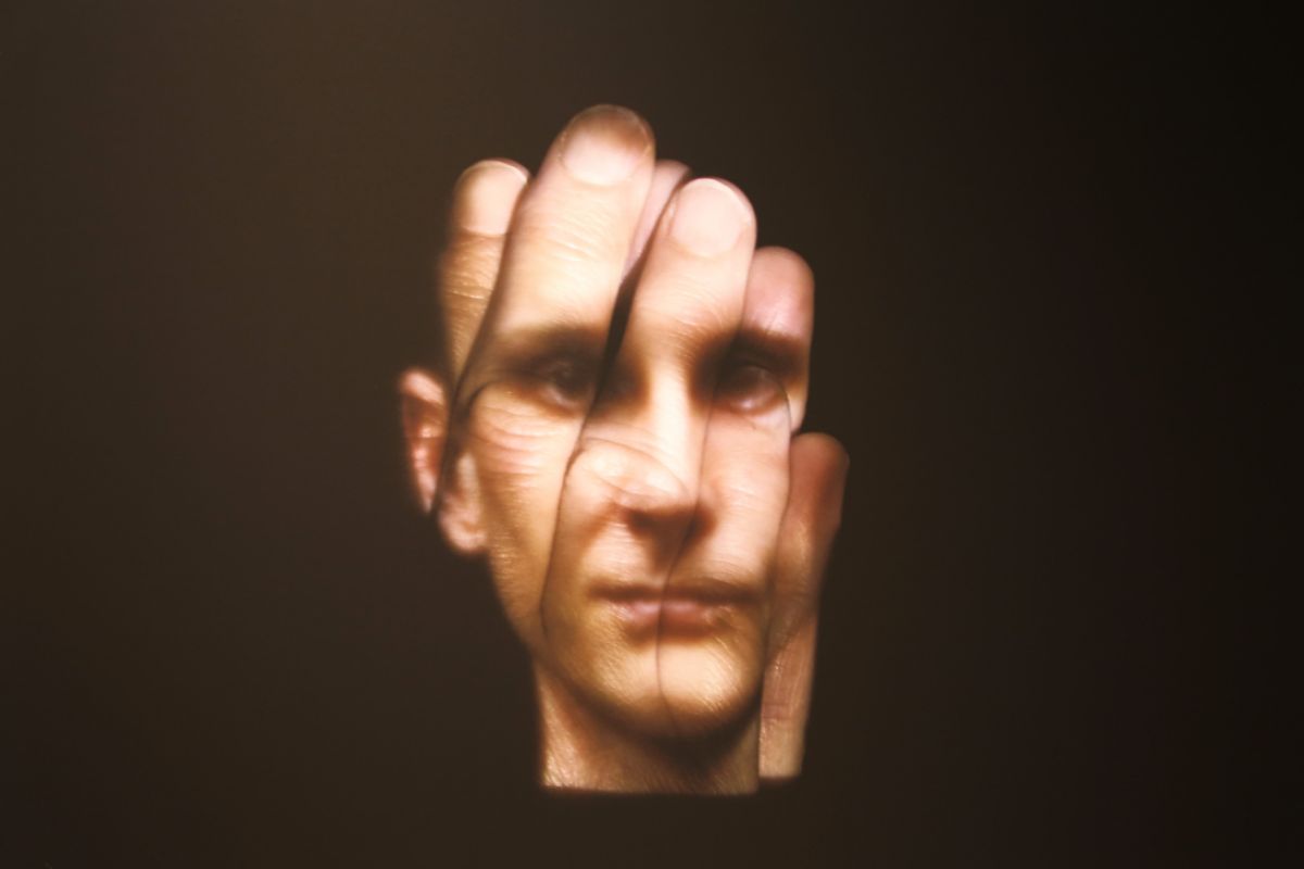 Photographic portrait of man's face on matte black background