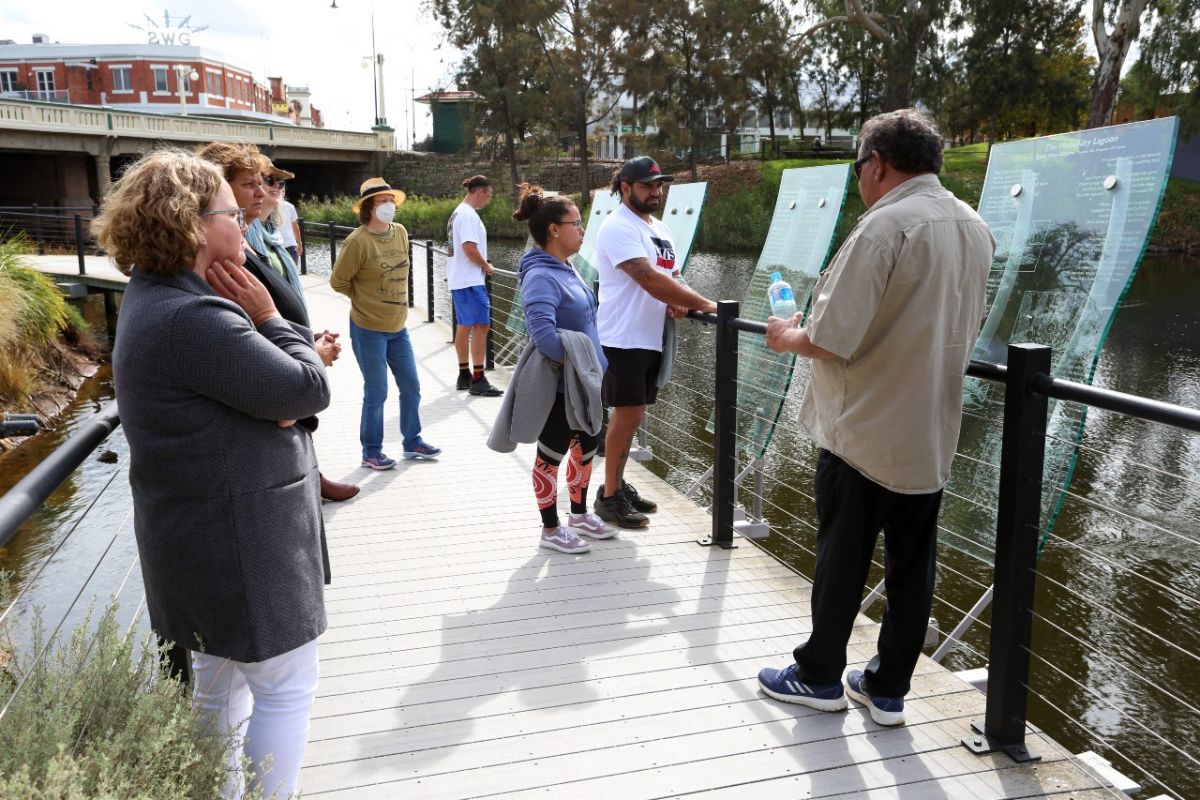 men and women on deck overlooking lagoon on cultural talk