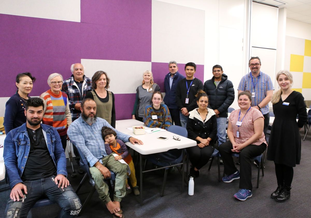 Group of men, women and children in library room