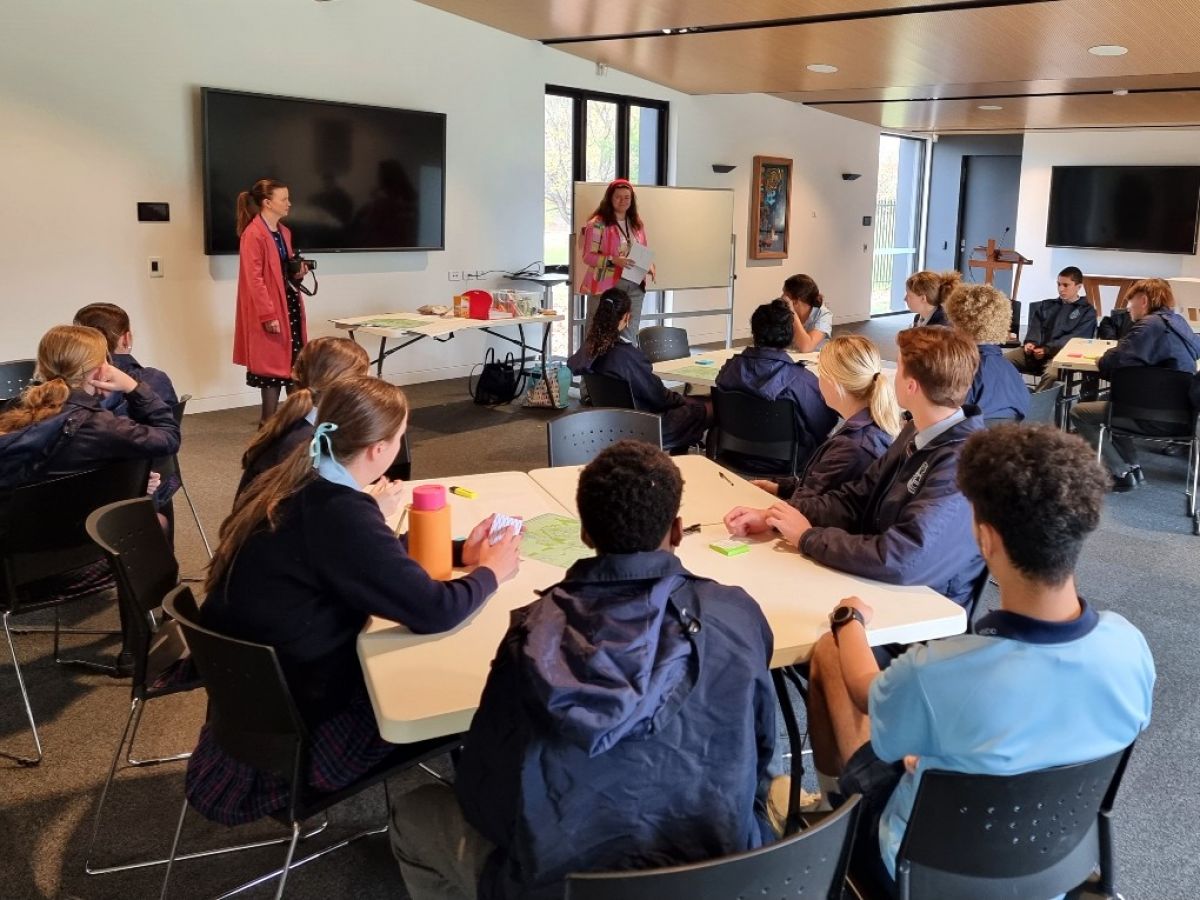 Council staff address a room of high school students