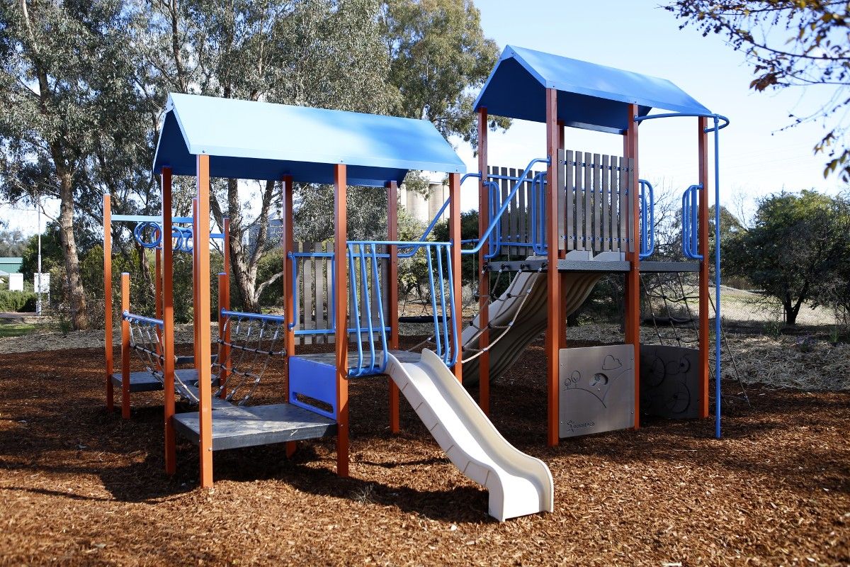 Playground equipment with slides and covered climbing areas