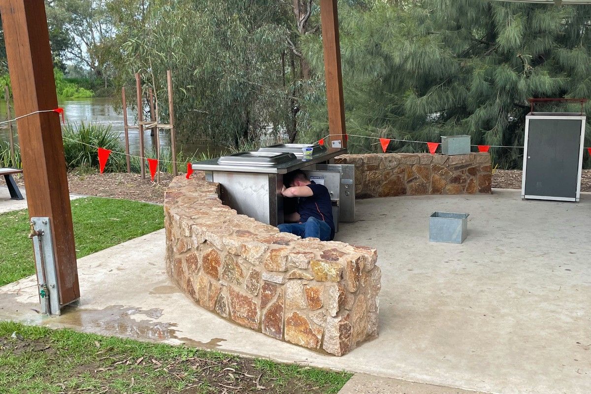 man working on disconnecting barbecue at Wagga Beach