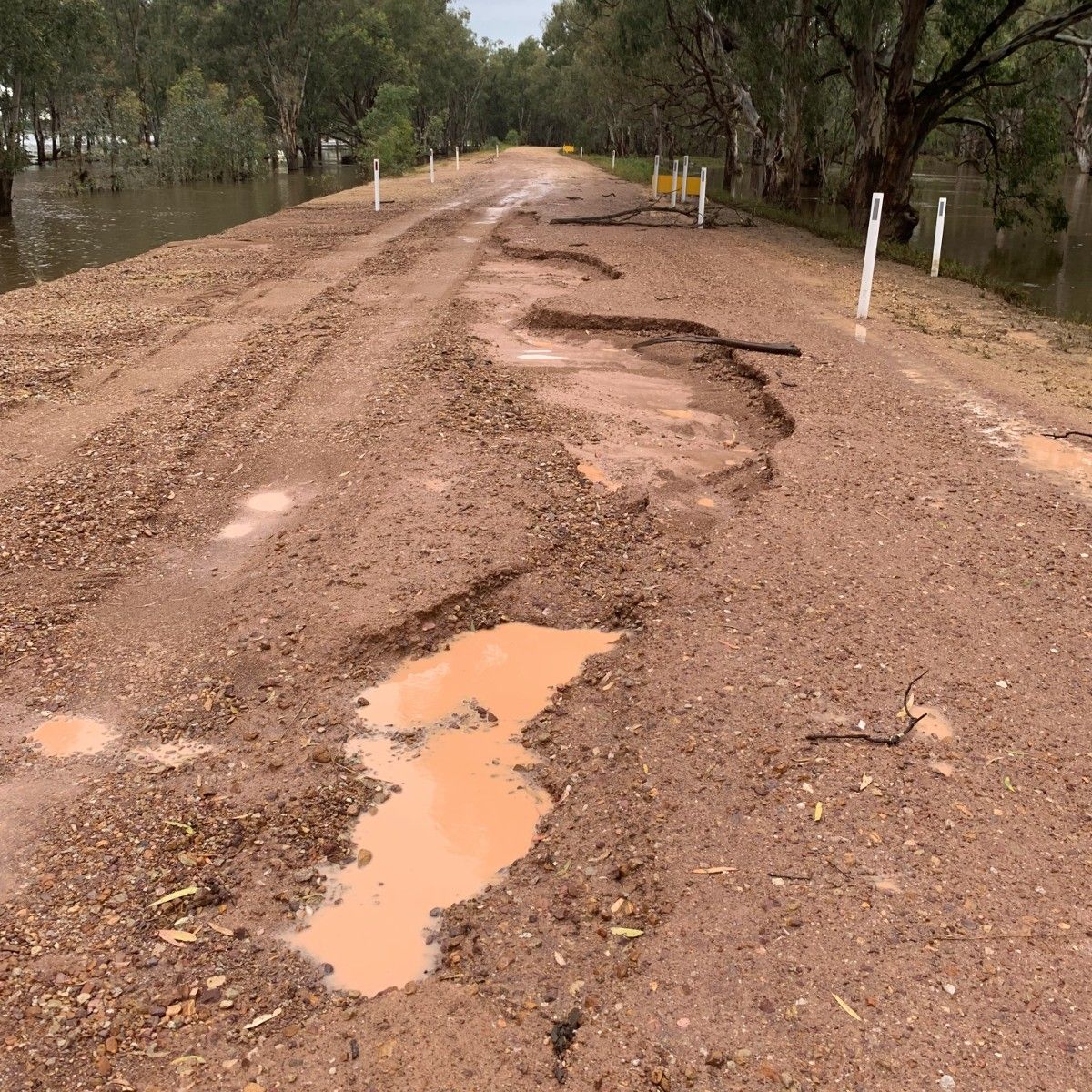 Road surface damaged by flood waters