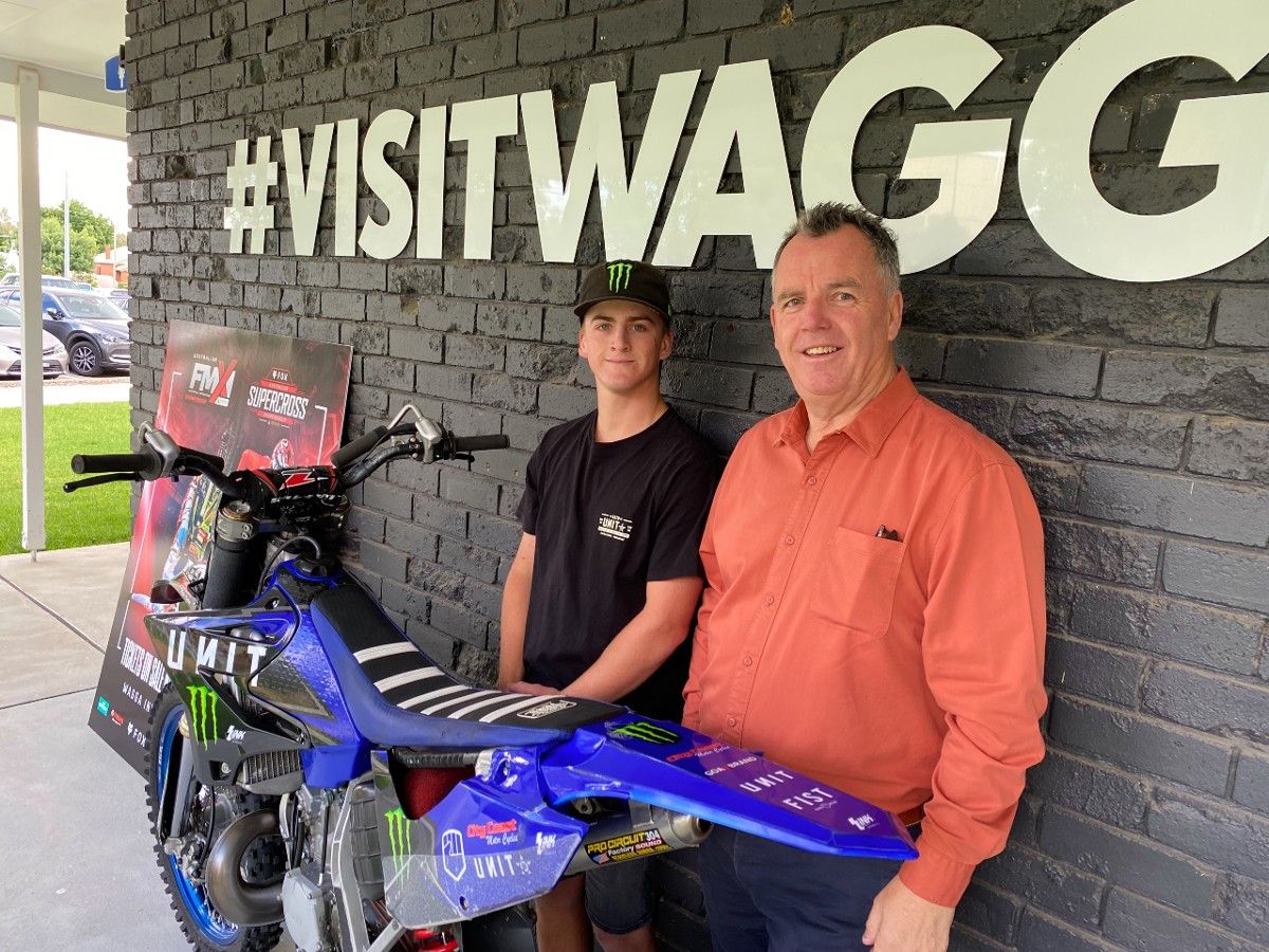 Motocross rider with his bike and Mayor Dallas Tout at Visitor Information Centre