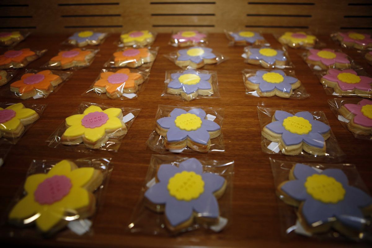 Rows of colourful biscuits with 'thank you' written in icing