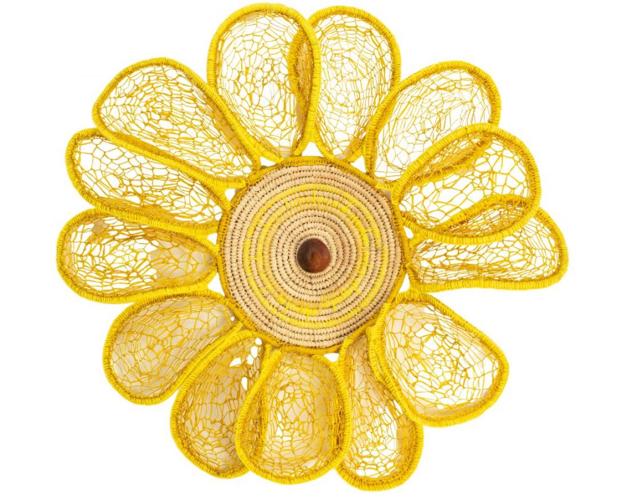 A yellow flower made from various natural materials. On a white background. 