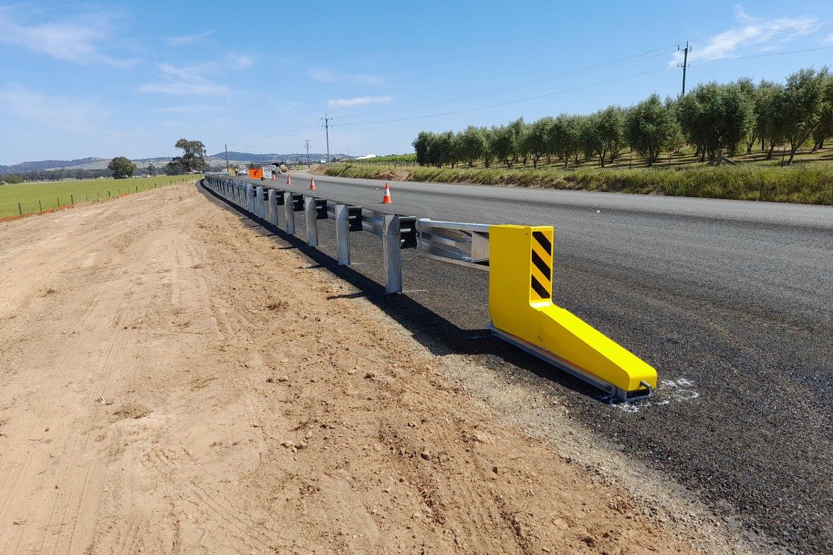 New guardrails installed beside freshly sealed road