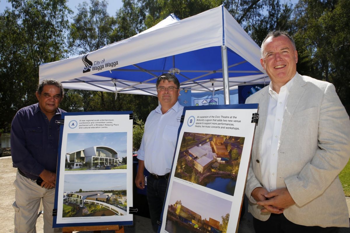 Three men standing next to marquee and A1 posters featuring  artist impressions of two projects proposed for Wagga Wagga.