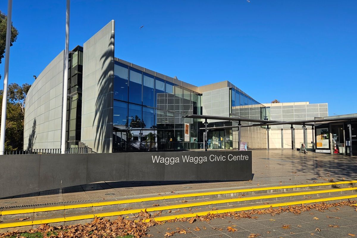 External view of front of Wagga Wagga Civic Centre building, with sign for building in foreground and front entrance to the building in background.