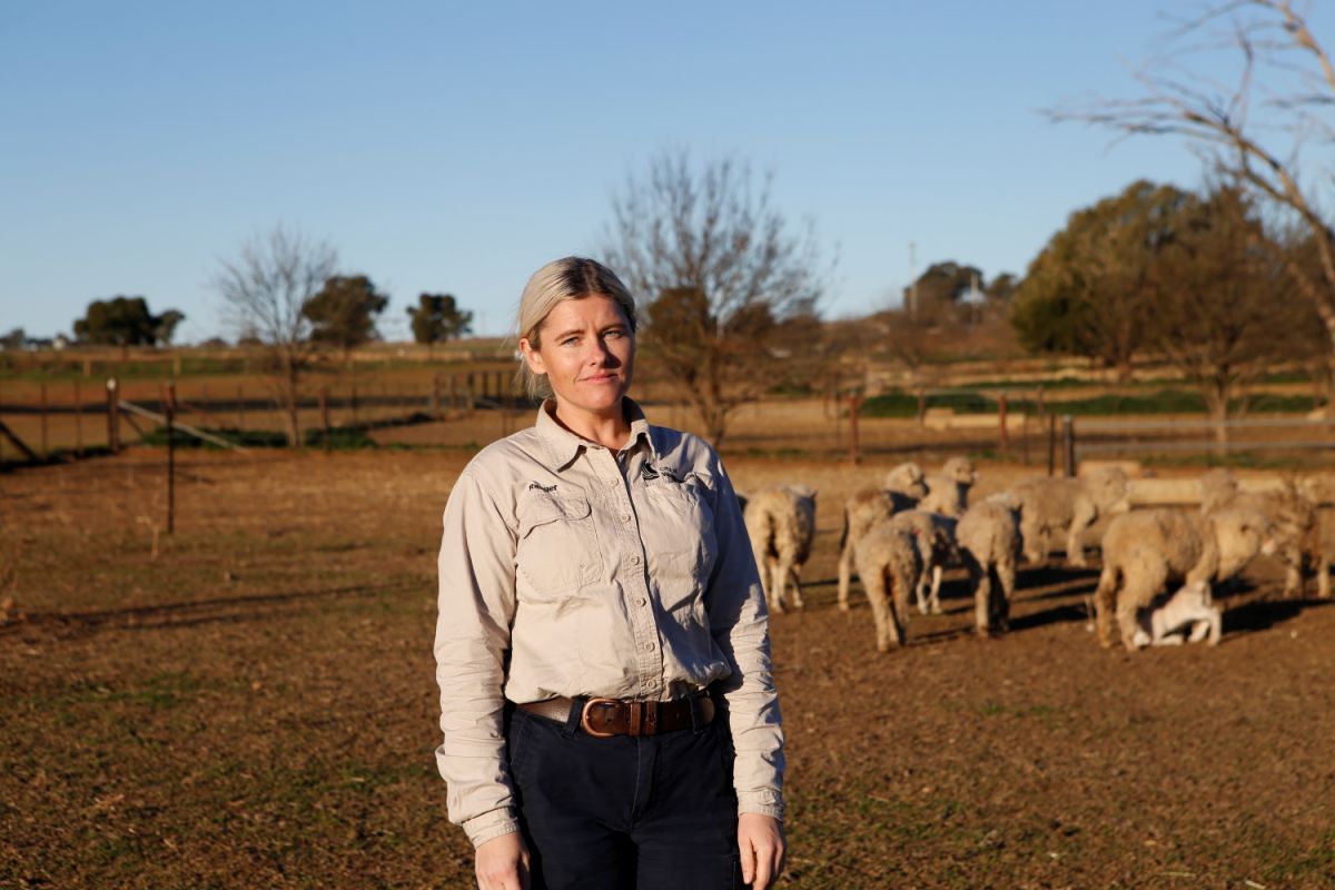 Woman standing in paddock.