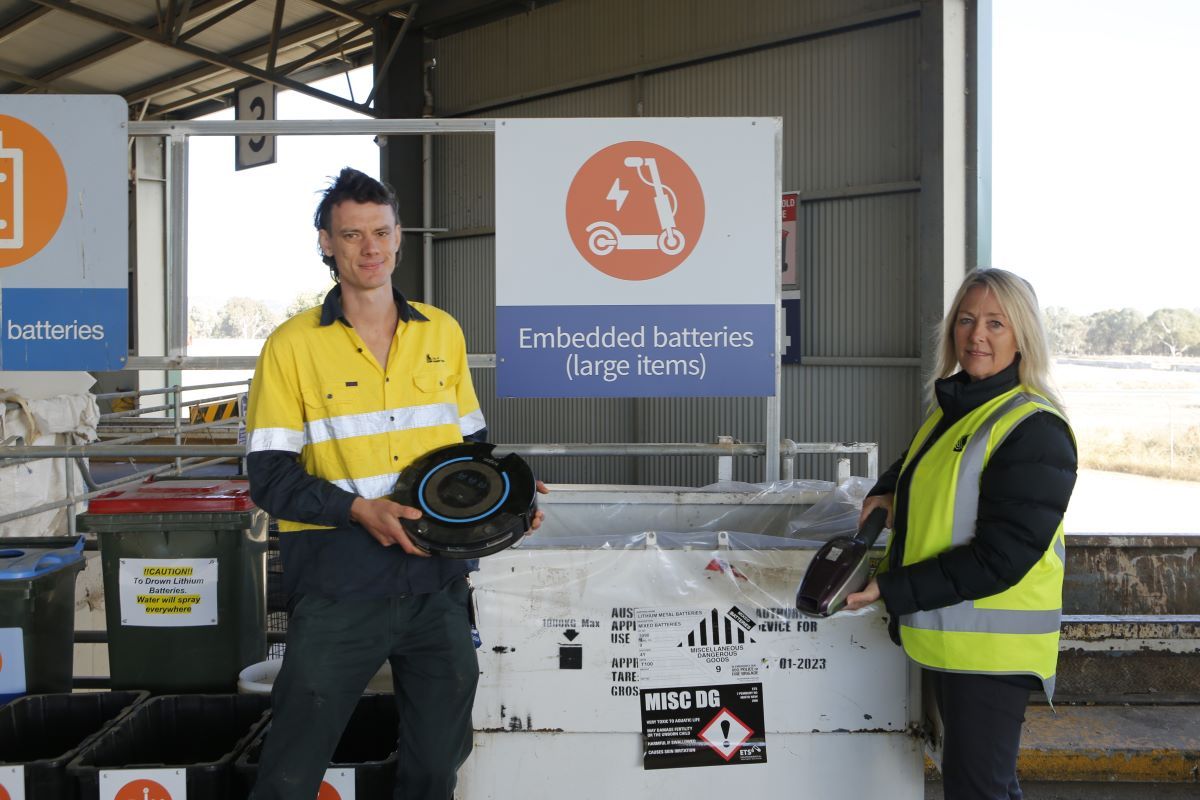 A man and a woman holding household items that have been disposed of via the embedded batteries disposal trial.