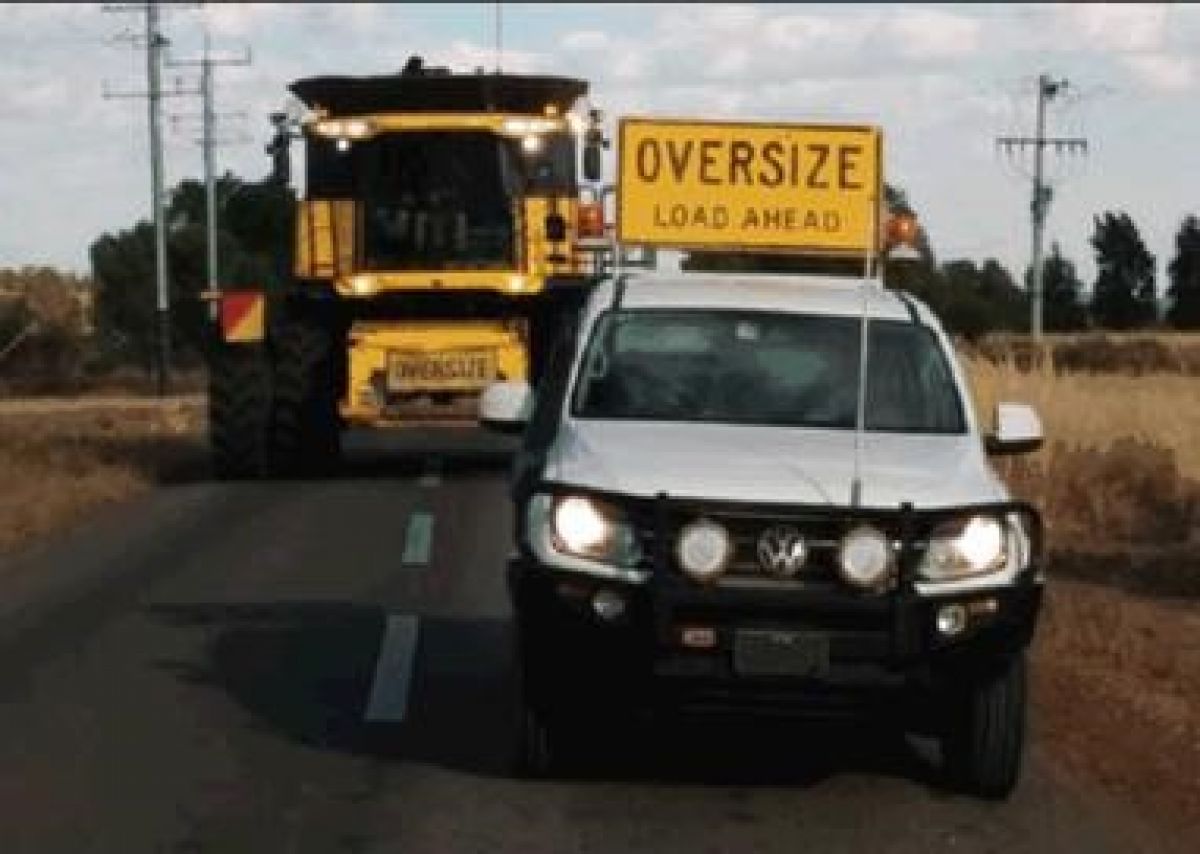 Header and ute on road