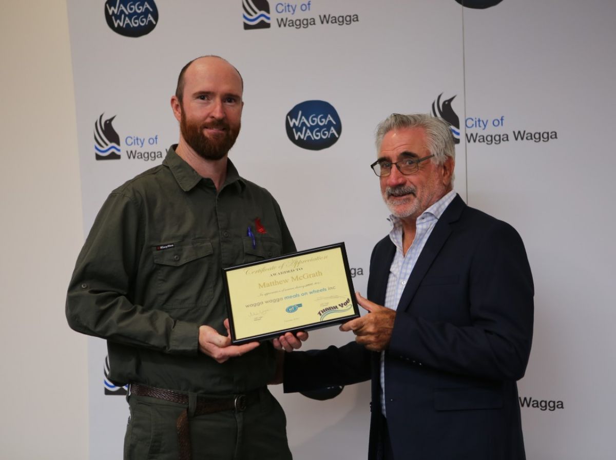 Two men holding a certificate