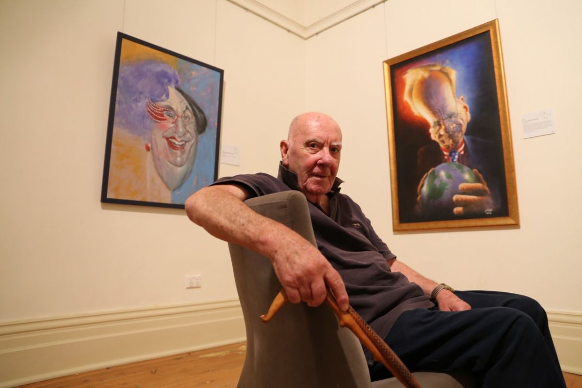 man sitting in chair at gallery