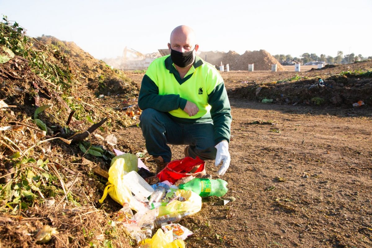 man posing in pile of organics