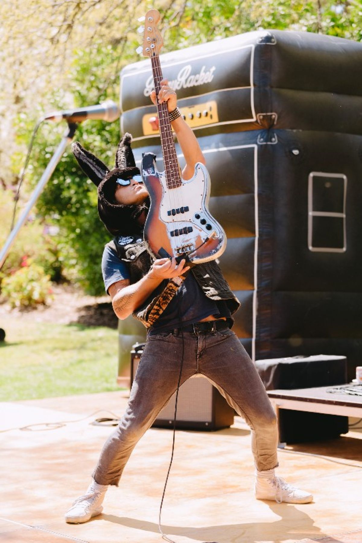 Man wearing bunny ears and playing guitar