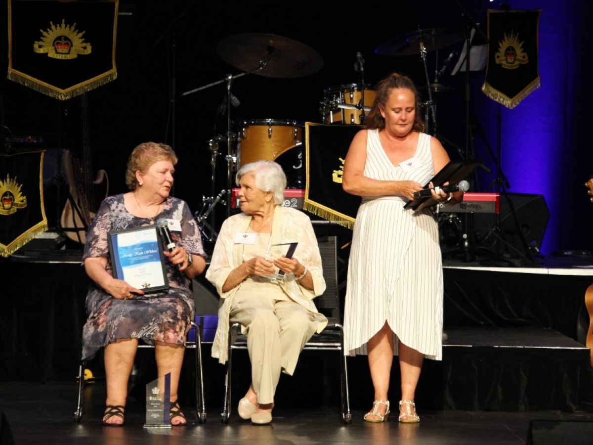 Three women on a stage