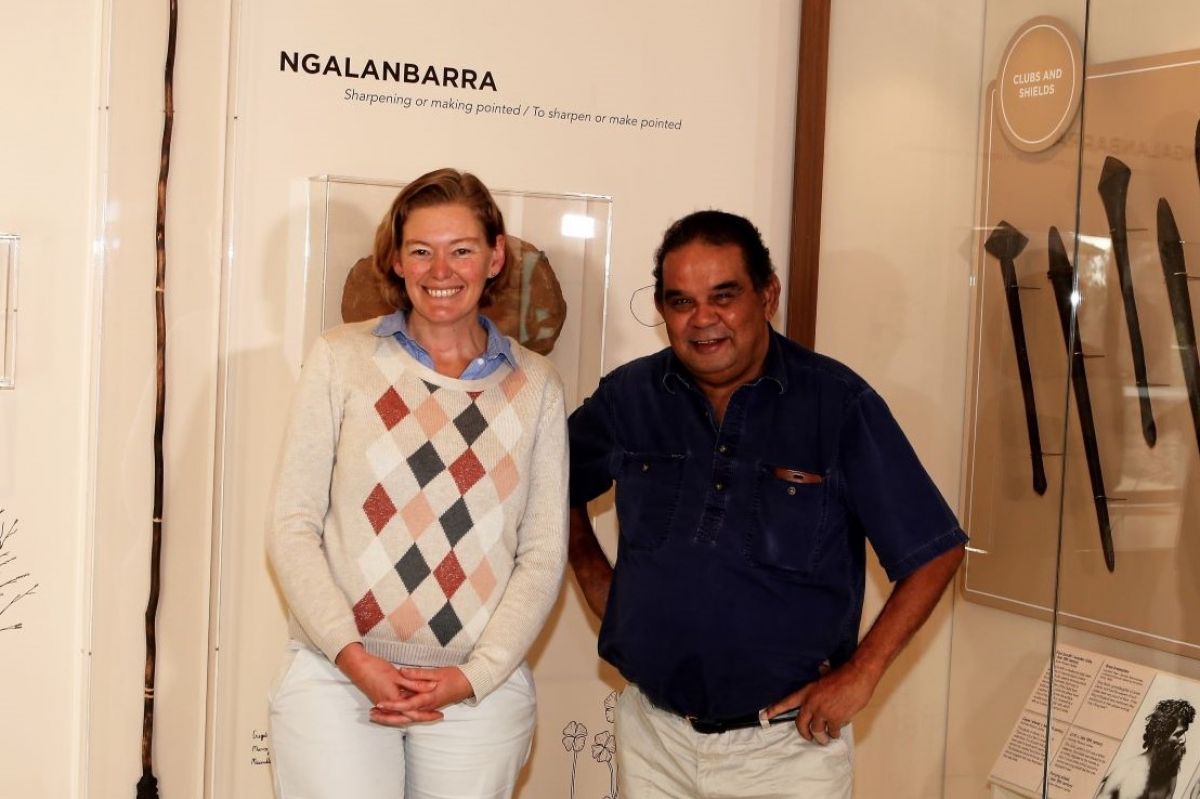 two people standing in a museum in front of First Nations artifacts. 