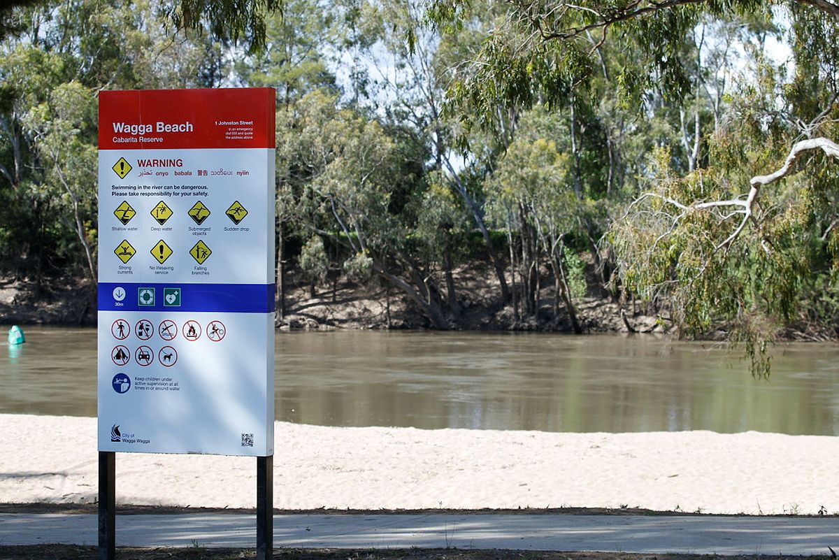 A warning sign next to a River