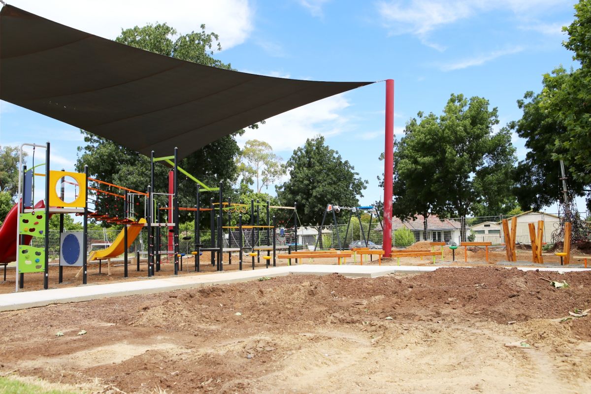 playground with landscaped soil underneath equipment