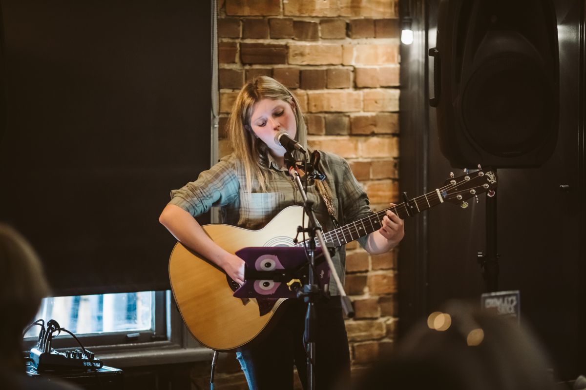 Woman playing guitar and singing