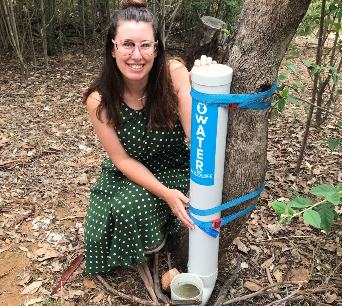 woman with water station in nature reserve