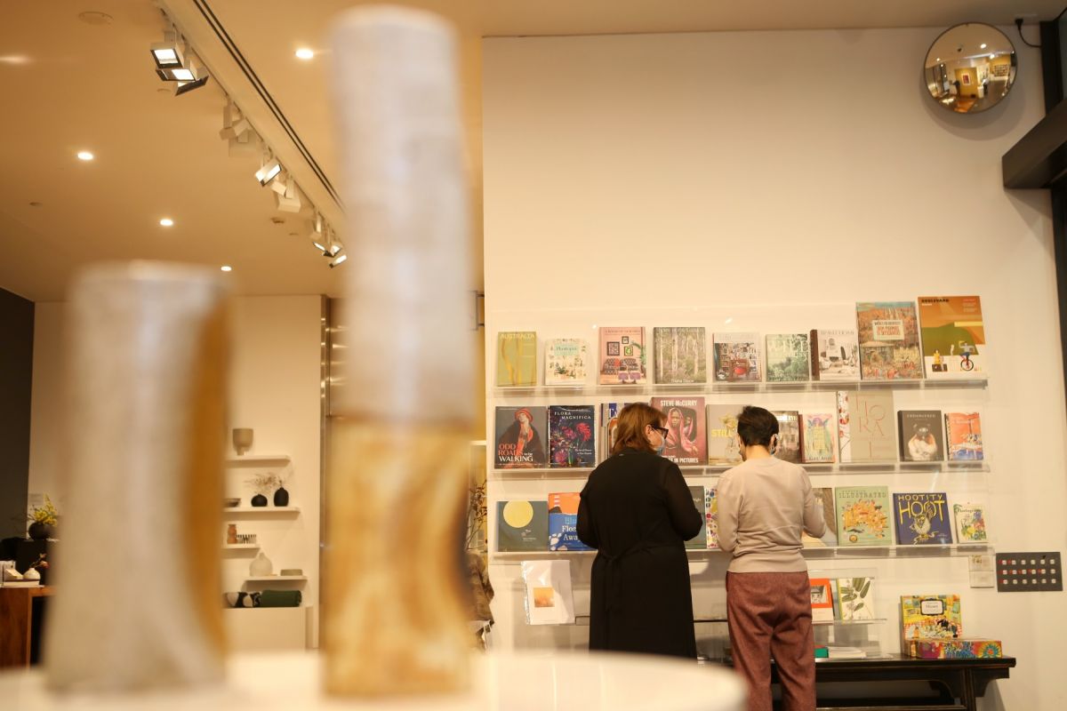 Two women standing next to bookshelf