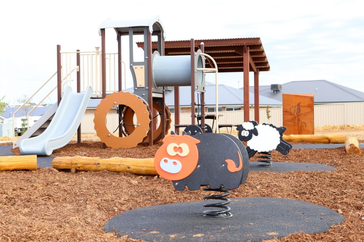 Play equipment in park with farmyard theme