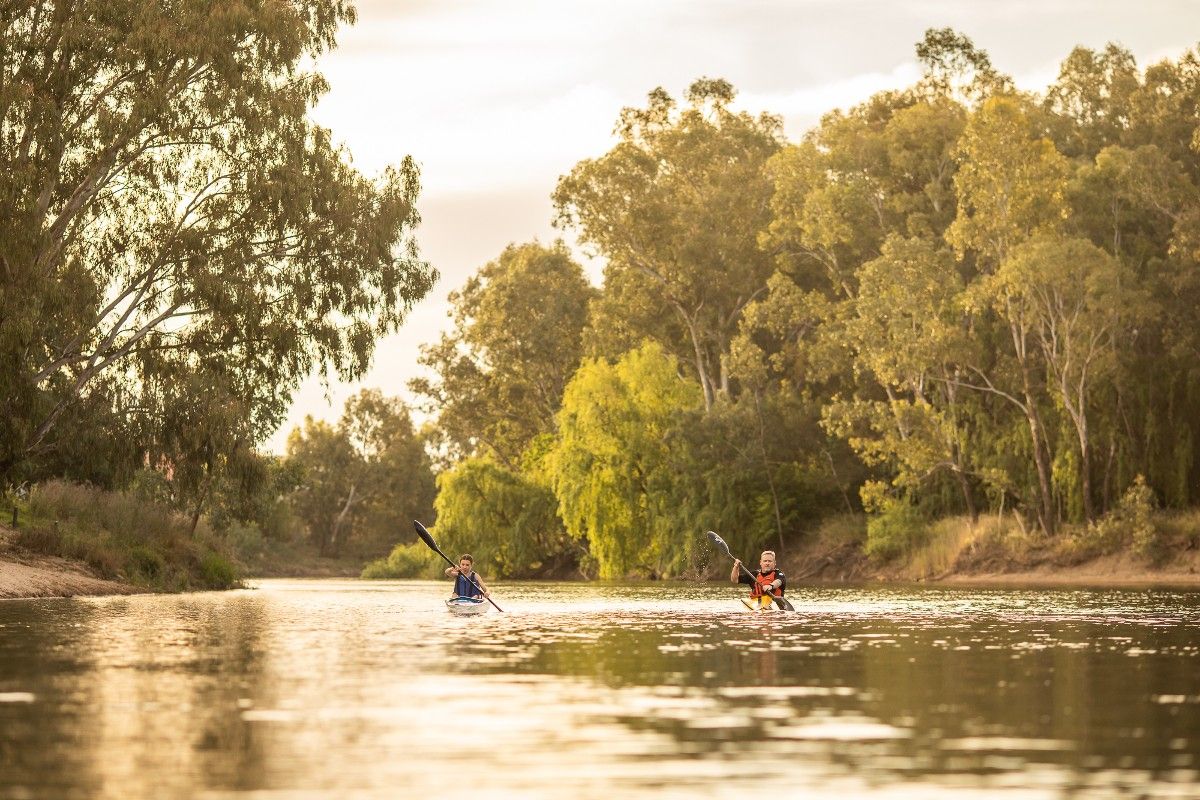 Two people rowing canoes on the Murrumbidgee River