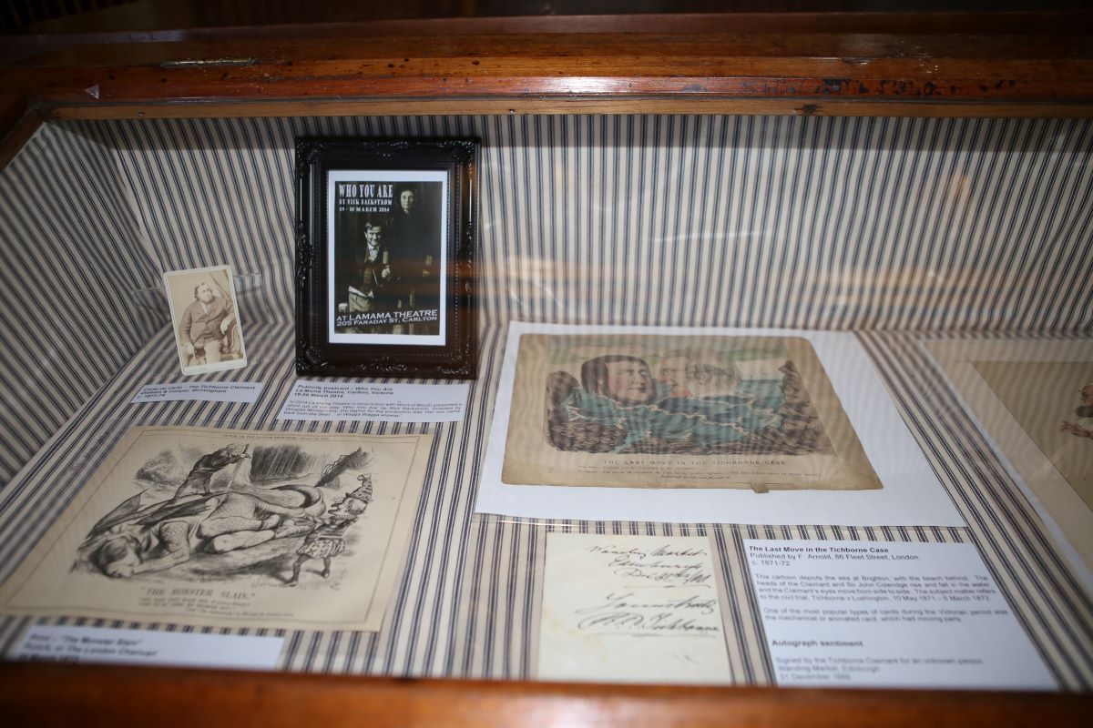 a glass case with historic files and illustrations