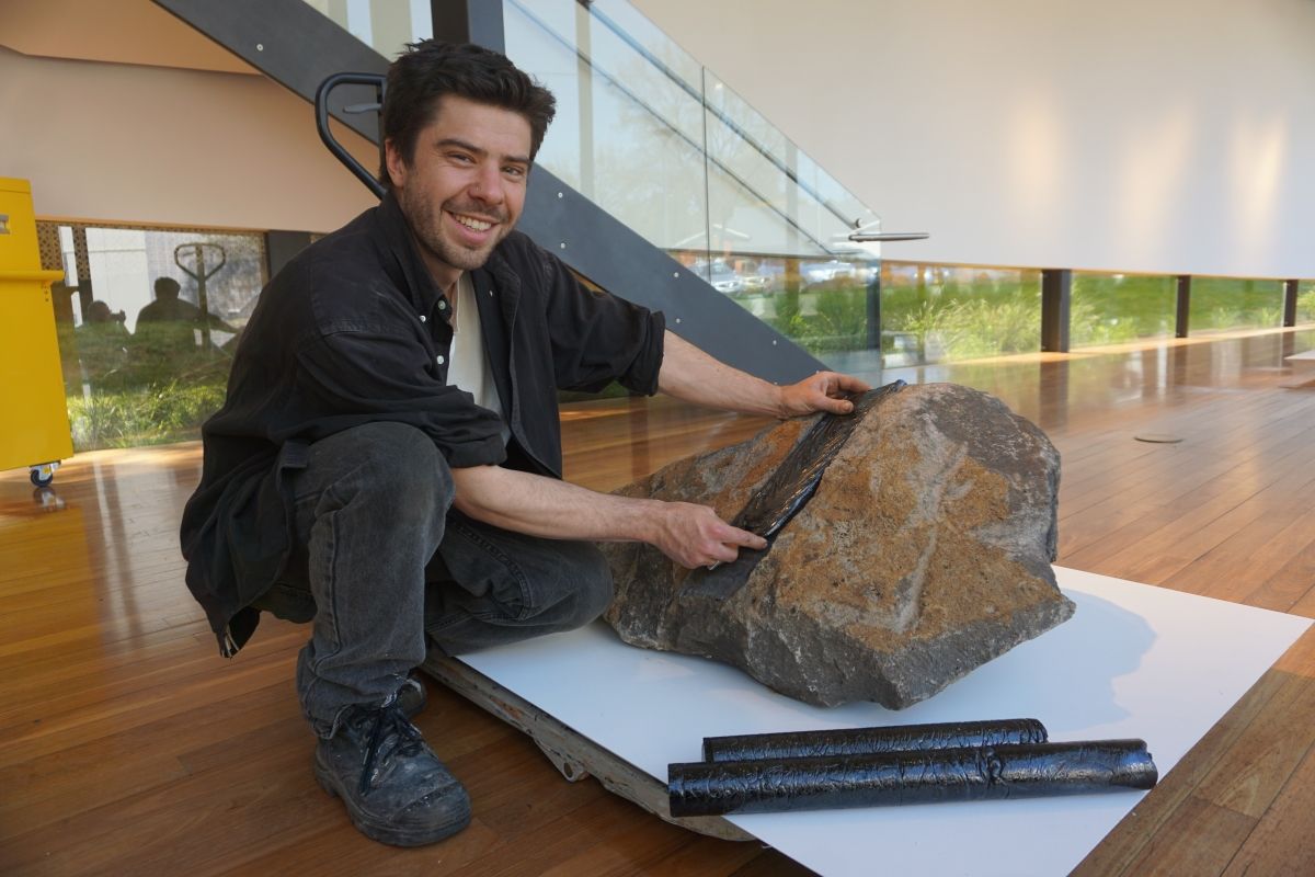 Artist Nicholas Burridge besides one of his works for Terraformed.