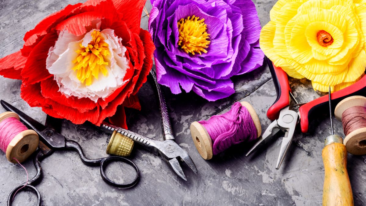 paper flowers, cotton, sewing equipment on table