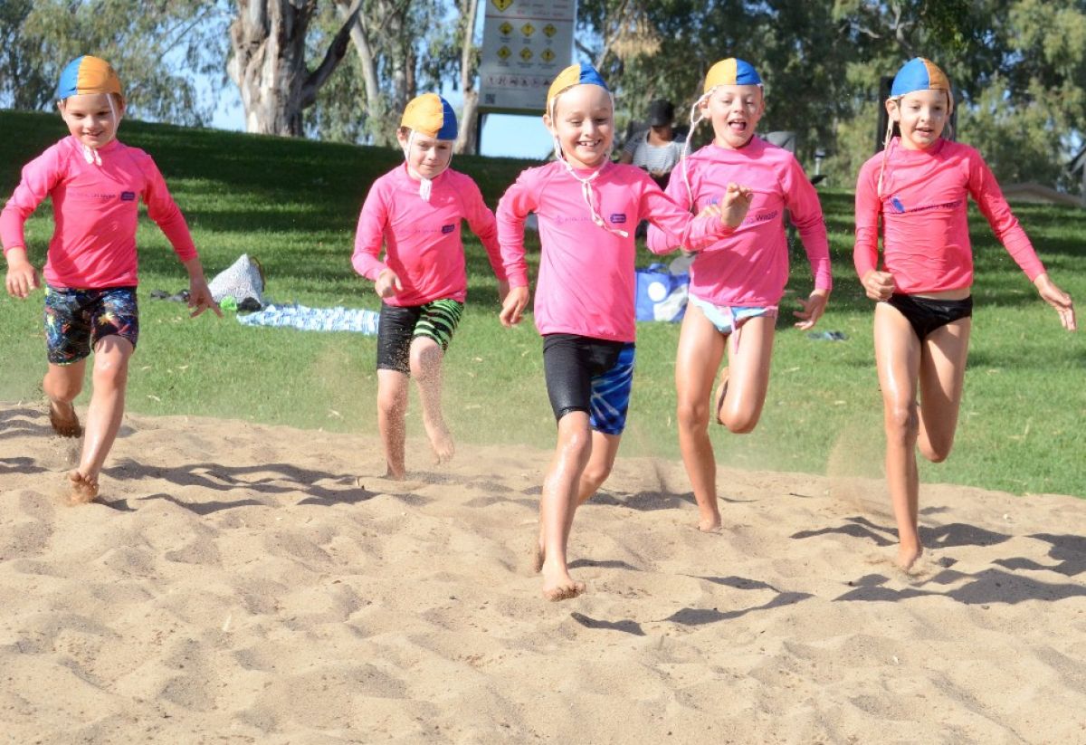 kids running on sand at beach