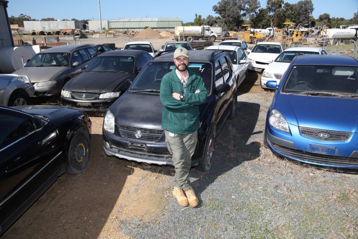 man sitting on car bonnet