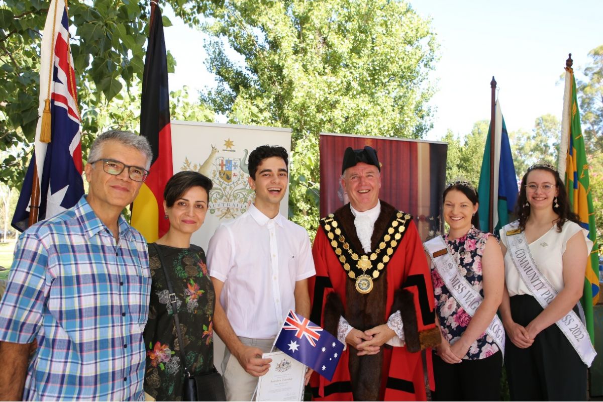 Family with Mayor in official robes on stage