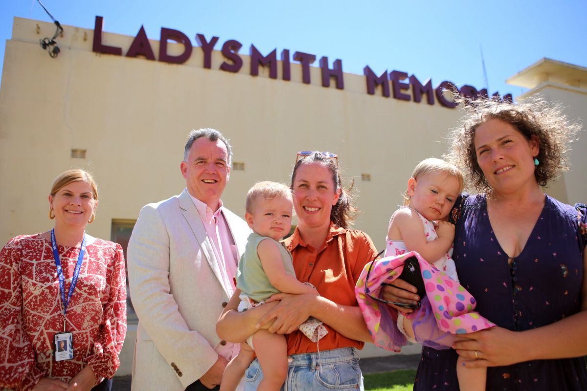 A group of people standing in front of a building