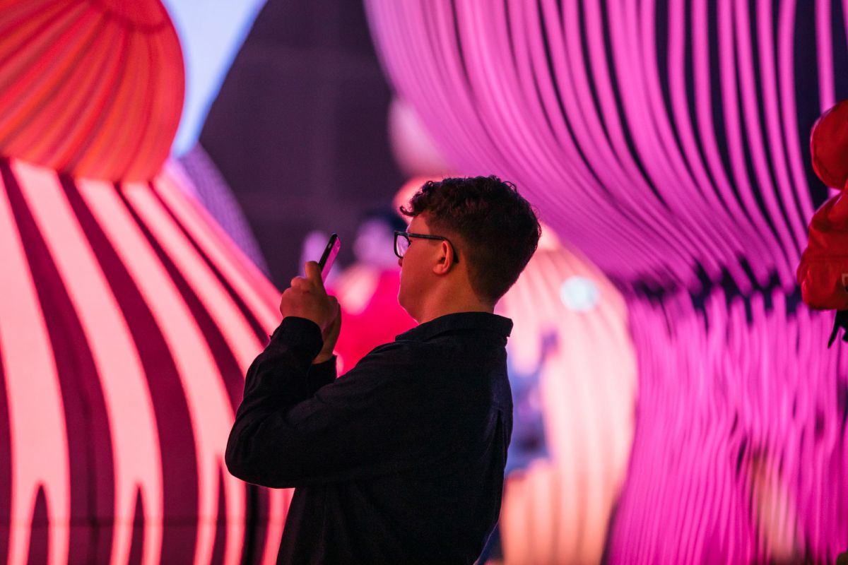 Person looking at light and movement installation