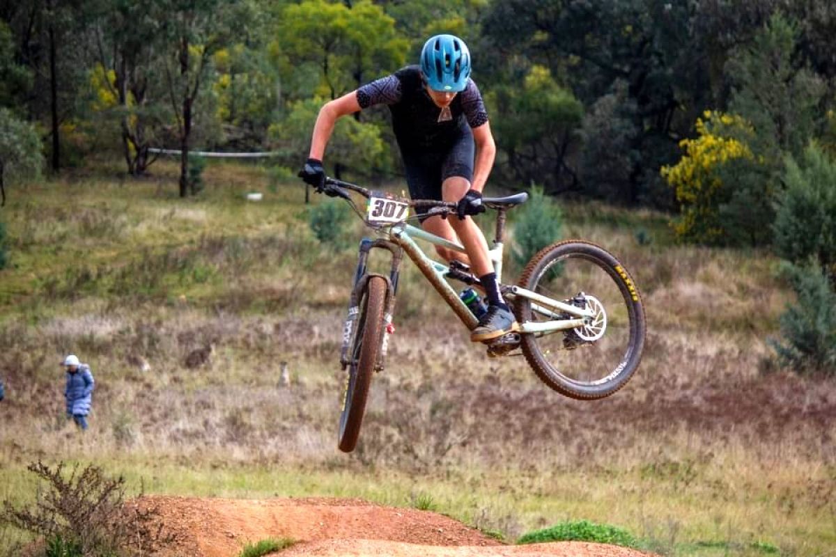 Mountain bike rider airborne on jump