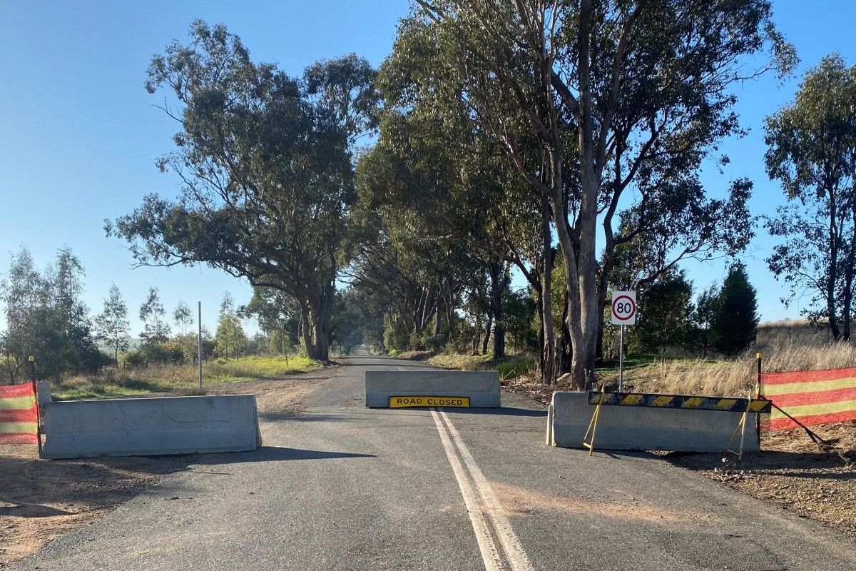Road with concrete barriers and road closed sign
