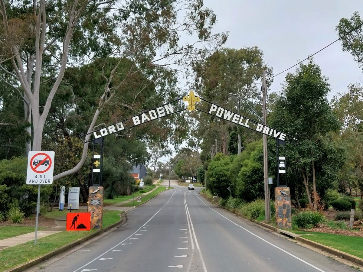 Arched Lord Baden Powell Drive gateway over road with roadworks sign in foreground