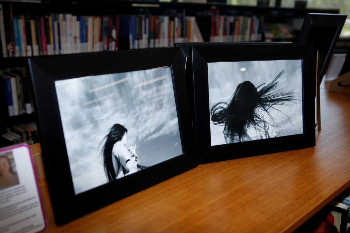 Two framed black and white photographs of a young woman with long black hair. 