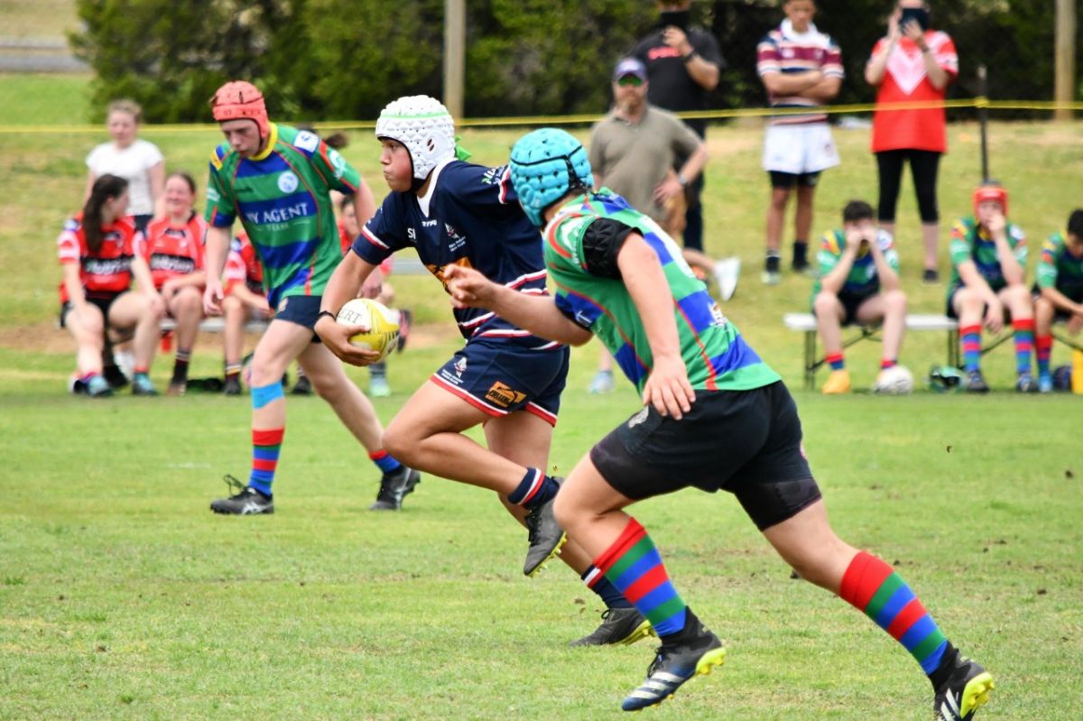 Young male rugby players in action in Super 7s game