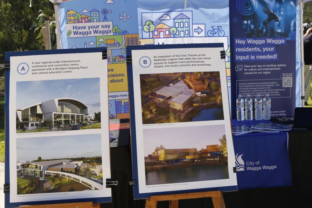 A1 posters of artist impressions of two proposed cultural facility projects, under pop-up information marquee.