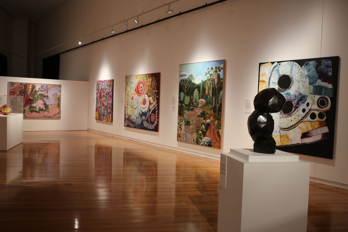 An art exhibition featuring large scale paintings. 